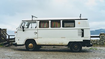 parked empty white van under cloudy sky