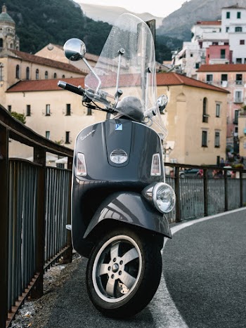 Parked Scooter Beside Railing