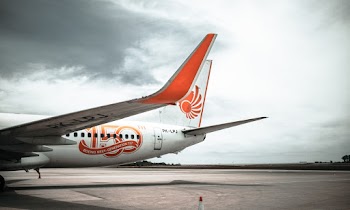 Parked White and Orange Airplane