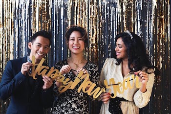 Partygoers Holding Happy New Year Sign
