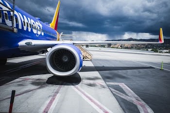 passenger plane on airport under gray cloudy sky