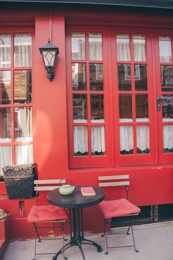 Patio Bistro Set Beside Red Wall