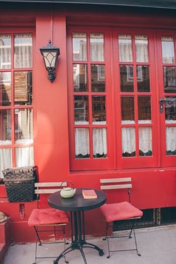 Patio Bistro Set Beside Red Wall · Free Stock Photo