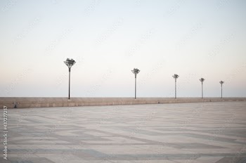 pavers ornament and street lights of vast expanses of squares Casablanca embankment Hassan II Mosque in sunset illumination