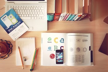 pencils and smartphone on top of books