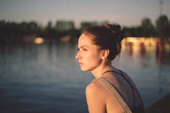 Pensive girl at the lake