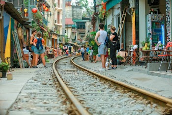 People Beside Train Rails