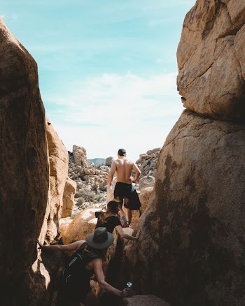 people climbing on rocks during daytime