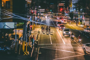 People Cycling on Road during Nighttime