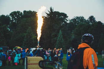 People Gathered Around Machine That Emits Flame