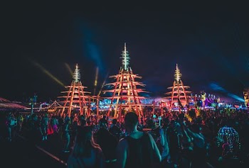 people gathering in front of brown tower during nighttime