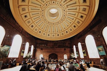 people gathering inside brown structure