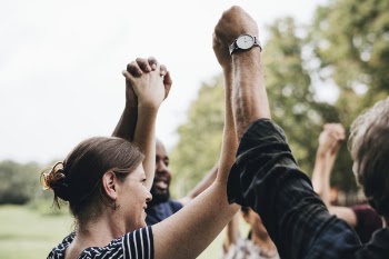 People Holding and Raising Hands