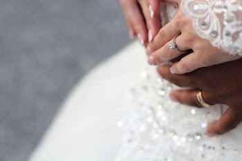 people holding hands while wearing gold-colored wedding rings