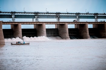 People in Boat Near Water Dam