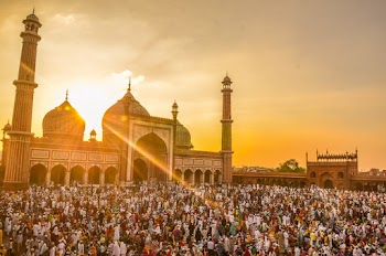 People in Front of Mosque During Golden Hour