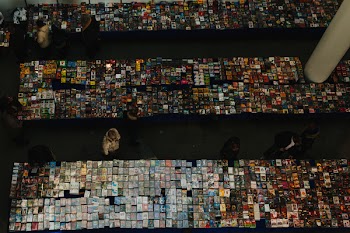 People in Front of Table of Books