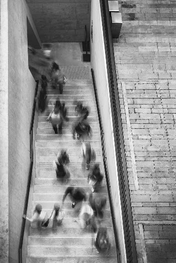 People in motion going through a doorway