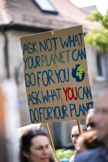 People in Parade With Multicolored Placard