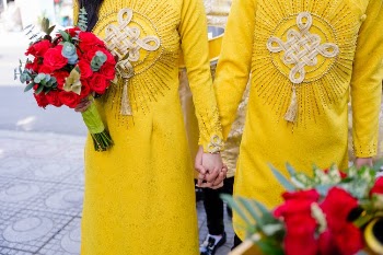 People in Yellow Clothes Holding Hands