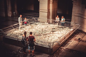People Leaning on Fountain Rails