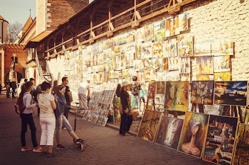 People Looking at Assorted-type Paintings
