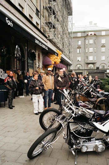 People Looking At Parked Motorcycles