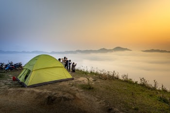 People Near Camping Tent Overlooking Sea of Clouds