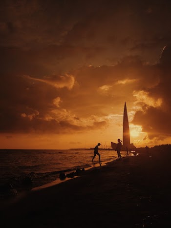 People Near Shore During Sunset