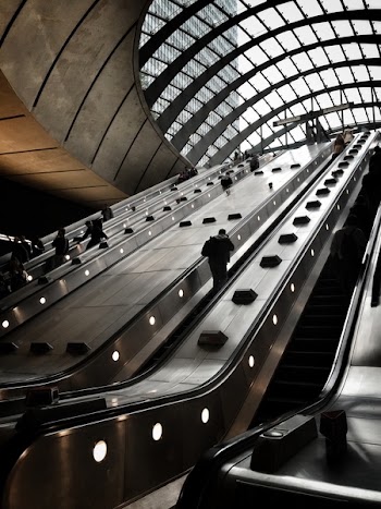People on Escalator Inside Building