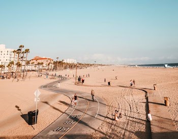 people on road and sand