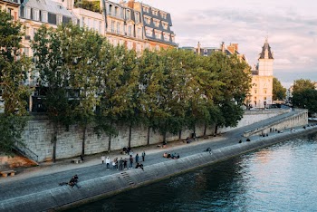 People on Road Beside Body of Water