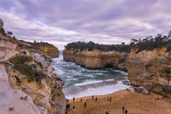 People on Shore Sea Cove Beside Cliff Nature Photography