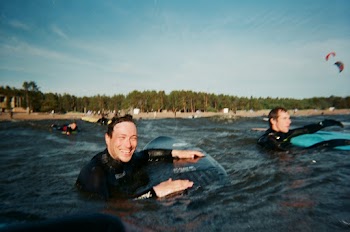 People On Surface Of Water With Surfboards