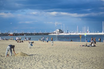 People on the beach. Pier &amp; marina