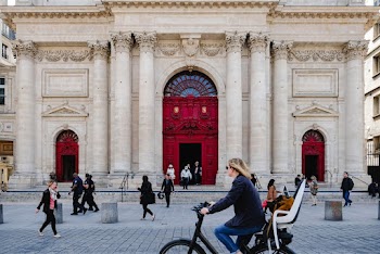 People Passing Near a White Building Close-up Photography