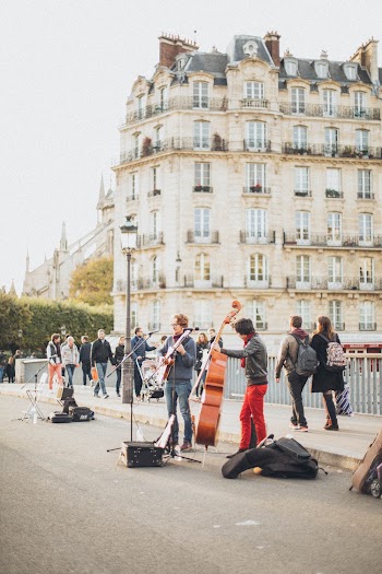 People Playing Instrument on Sidewalk