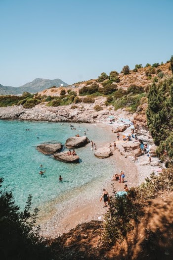 People Playing on Rocky Beach · Free Stock Photo