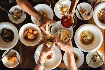 people raising their drinking glasses