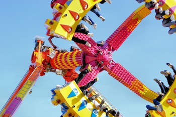 People Riding a Swing in the Amusement Park