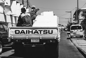 People Riding At The Back Of A Truck