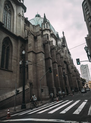 People Riding Bike Near Buildings