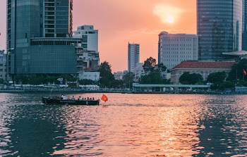 People Riding on Boat Sailing Along Calm Waters