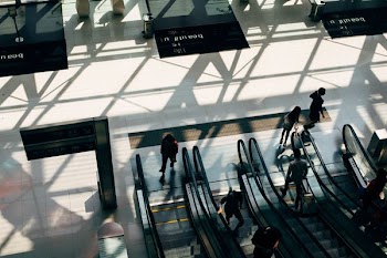 people riding on escalator