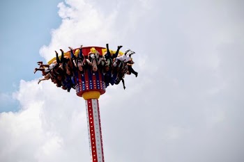 People Riding on White and Red Carnival Rides