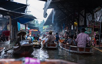 People Riding Wooden Canoes On River