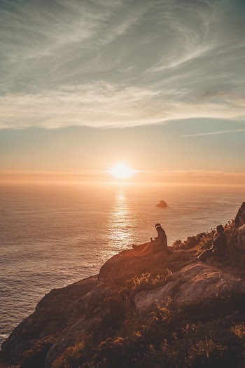 People Sitting By The Cliff