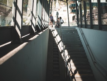 People Sitting on Bench Near Staircase