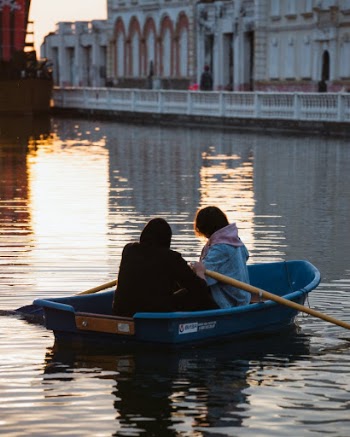 People Sitting on Blue Boat
