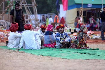 People Sitting on Green Textile